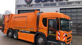 Orange Scania refuse truck