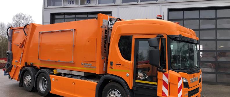 Orange Scania refuse truck