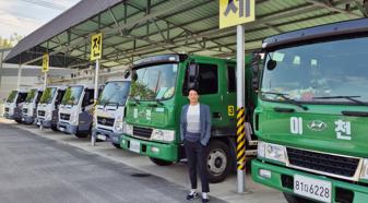 Person standing next to some parked trucks