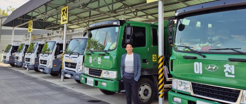 Person standing next to some parked trucks