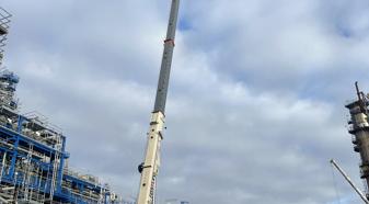 view is looking up at a crane in a construction site