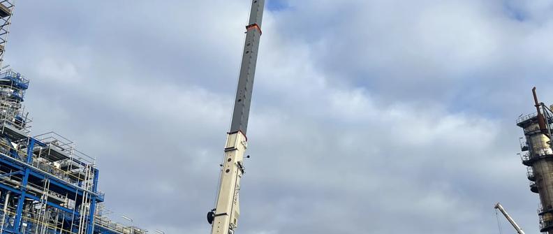 view is looking up at a crane in a construction site