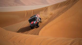 Truck driving through the sand