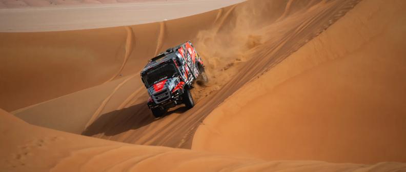 Truck driving through the sand