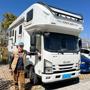 Person standing next to an RV