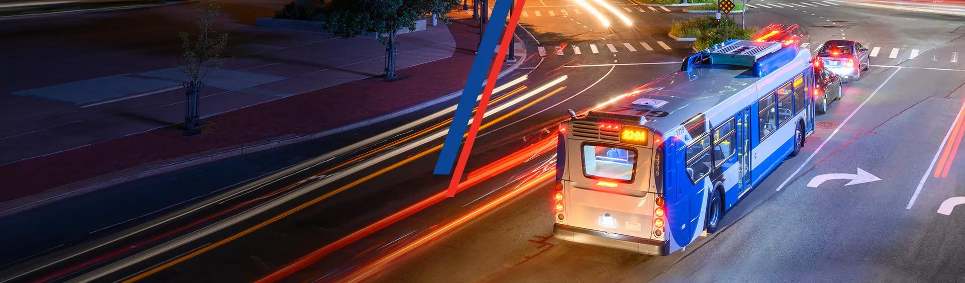 Image of a city bus traveling on a busy street.