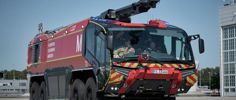 An ARFF equipped with an Allison 4800R travels down a road at the Munich Airport.