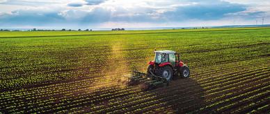 Tractor cultivating field at spring,aerial view