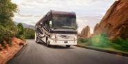 A photo of an RV driving on a road