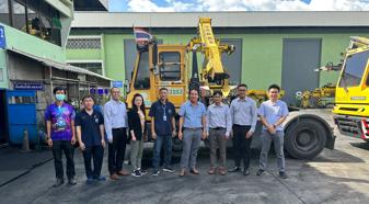 Group of associates in front of a tractor