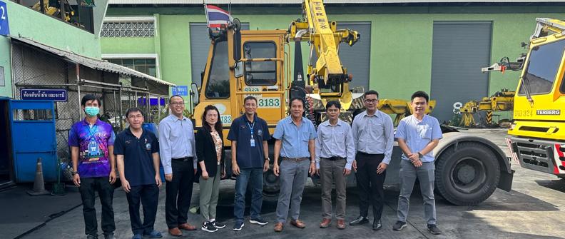 Group of associates in front of a tractor