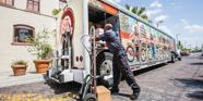 A photo of a food delivery truck with a worker in Florida.