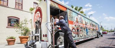 A photo of a food delivery truck with a worker in Florida.