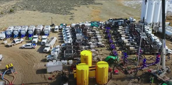 Trucks lined up at a hydraulic center.