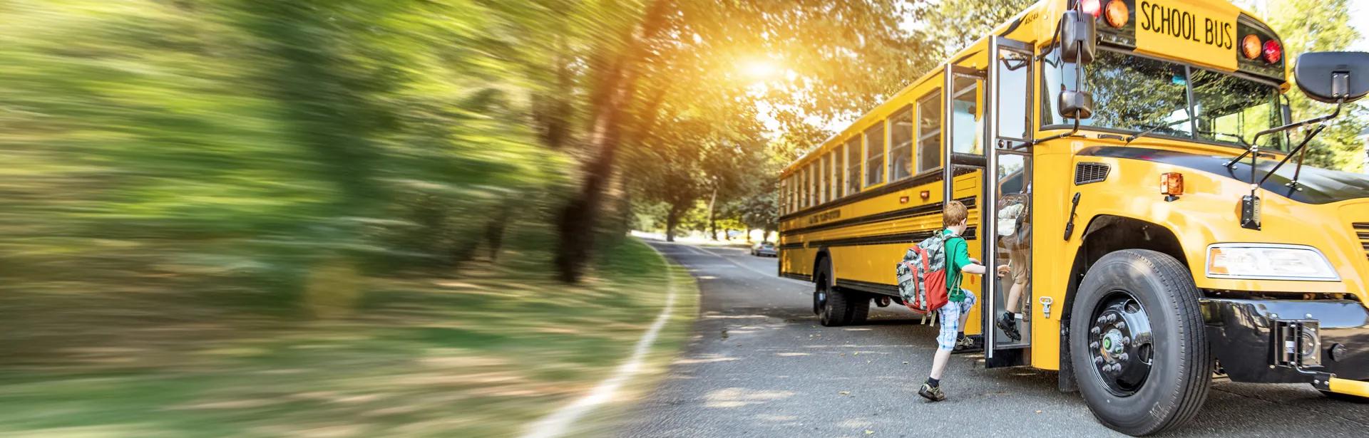 child getting on a school bus