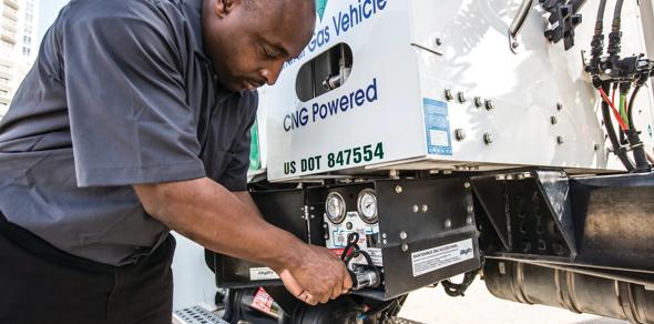 man filling truck up with gas