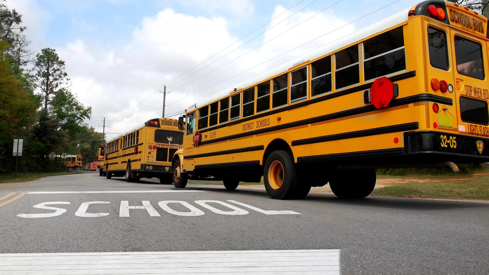 School buses lined up at school crosswalk