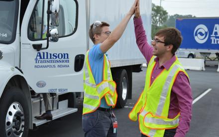 2 male students high 5 at Ride n' Drive